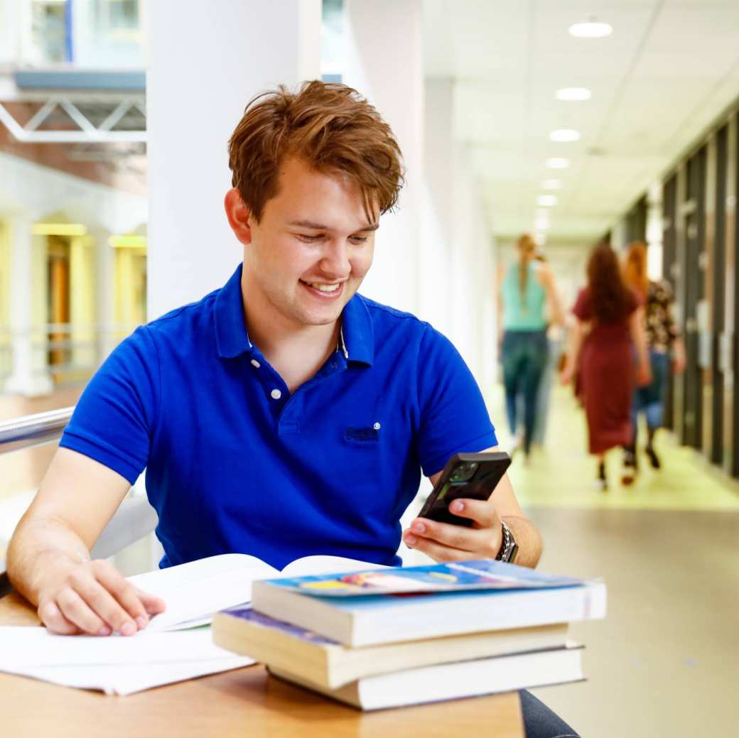 man student boeken lezen hal gang