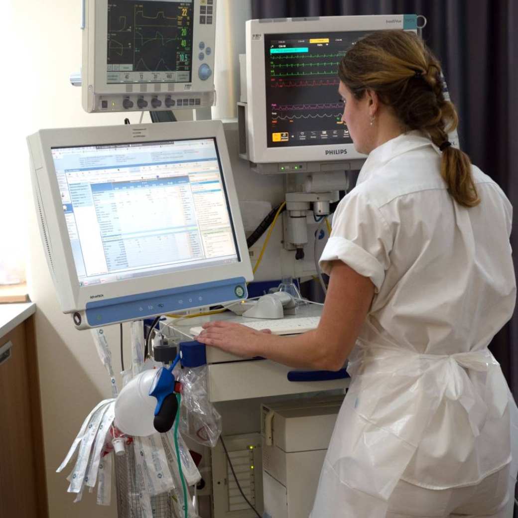 102309 Een intensive care verpleegkundige is bezig met de digitale administratie van haar patient