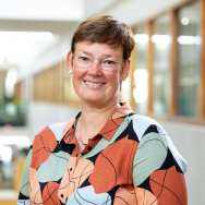 Portretfoto Ankie van der Kruijs, brildragend en bont gekleurde blouse