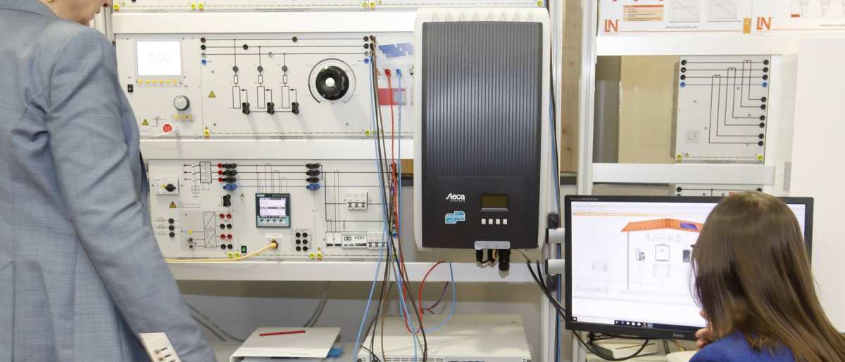 Joke Westra en Patricia Boogaard  bij de panelen (op de rug). SEECE, SEE, Lectoraat Meet- en Regeltechniek, HAN W@TTS, elektriciteitsnet, energietransitie.