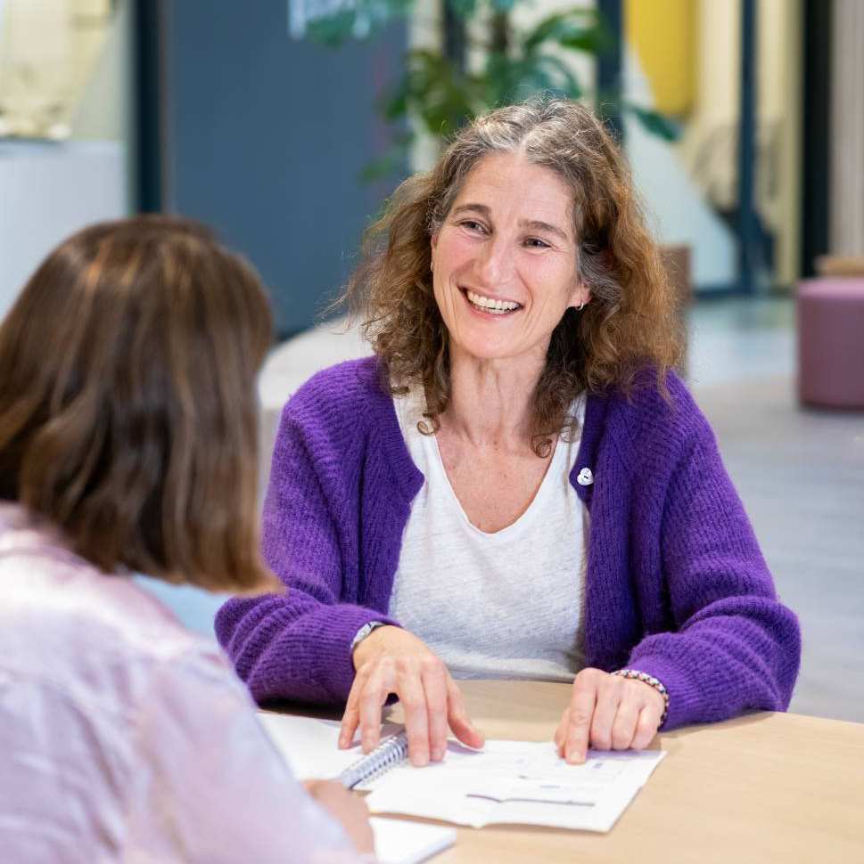 2 studenten aan tafel in gesprek