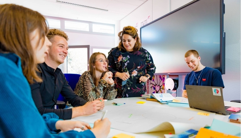 meerdere studenten van learning and development aan het praten samen met een docent