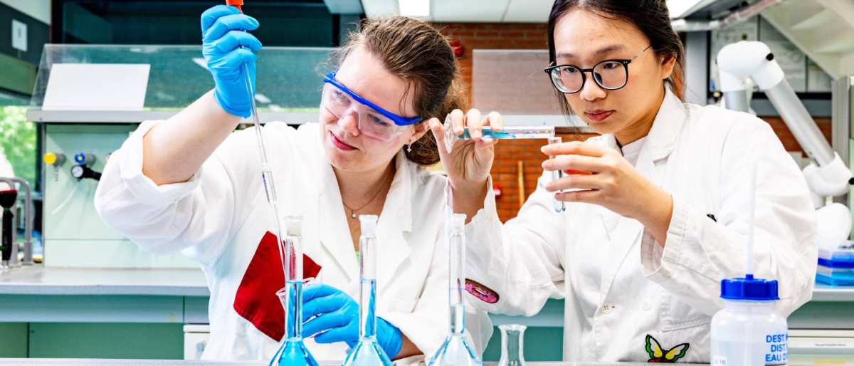 studenten pipetteren in het chemielab