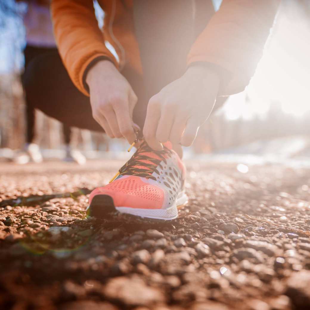 cursist sport headerbeeld, werken aan je geluk, leven lang ontwikkelen. Sportschoen veters strikken