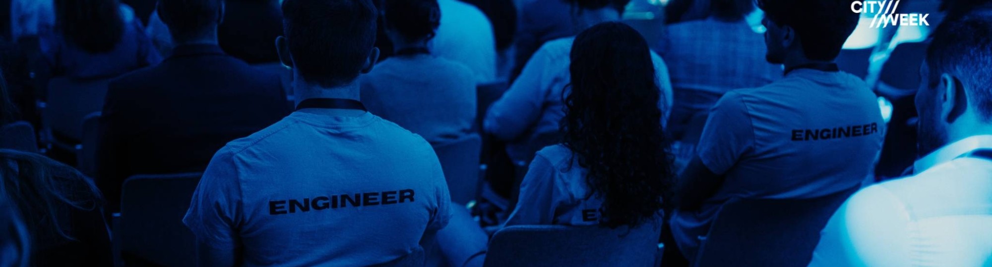 Studenten in de zaal met het logo van de Arnhem Electricity Week