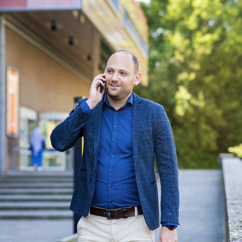 deelnemer master Business Sales samenwerken aan de telefoon op weg naar college.