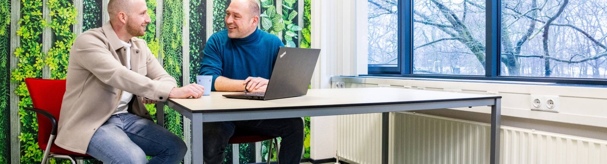 Een studieadviseur en docent heeft een gesprek met een student Bedrijfskunde deeltijd