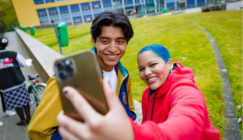 Diego and Chadionne smiling and taking a selfie at Arnhem Campus