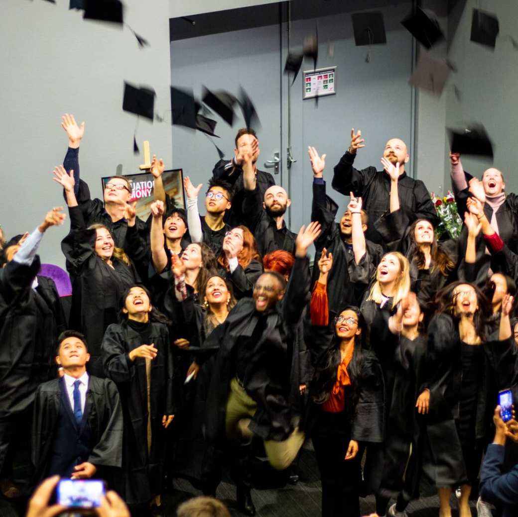 The picture shows the throwing of the hat by ISB graduates.