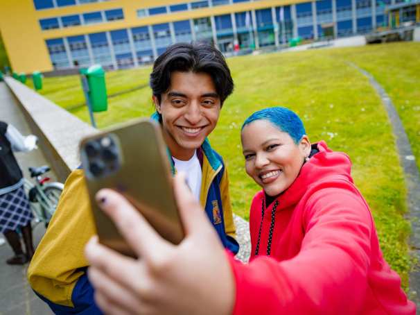 Diego and Chadionne smiling and taking a selfie at Arnhem Campus