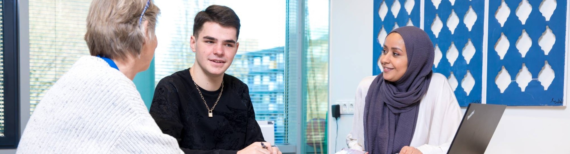student in gesprek met wijkdocent en professional