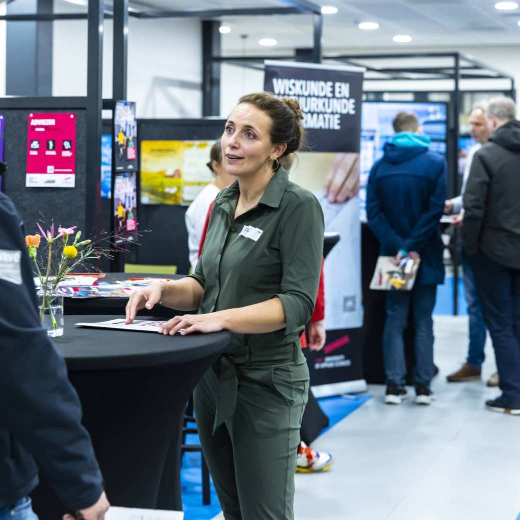 Open Avond Arnhem. Bezoeker in gesprek op informatiemarkt. Ruitenberglaan 31, Arnhem