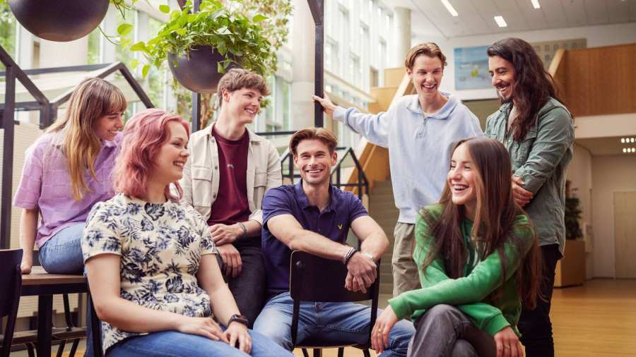 werving voltijd campagne, groepje van zeven studenten hebben lol in de hal.