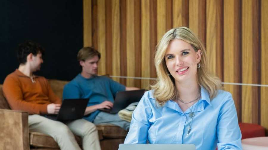 Studenten hbo Logistiek zit aan tafel en kijkt in de camera