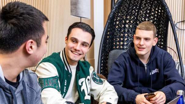 Studenten hbo Logistiek in overleg met een laptop erbij