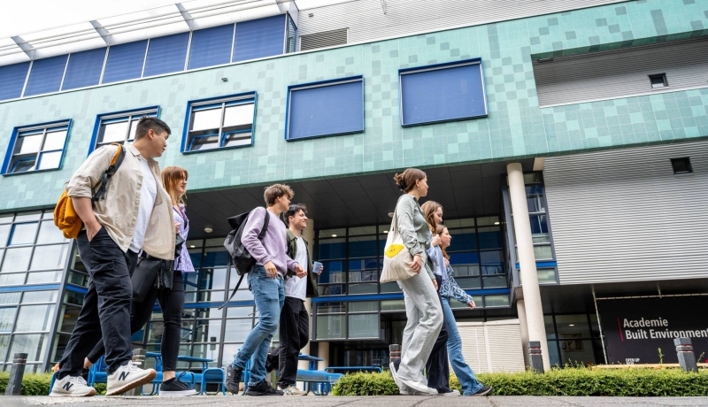 studenten lopen op de campus in Arnhem naar een ander gebouw
