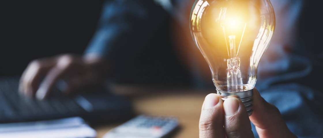 Foto van een gloeilamp die wordt vastgehouden door een lamp