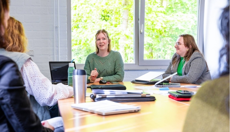 Drie vrouwen die aan het overleggen zijn