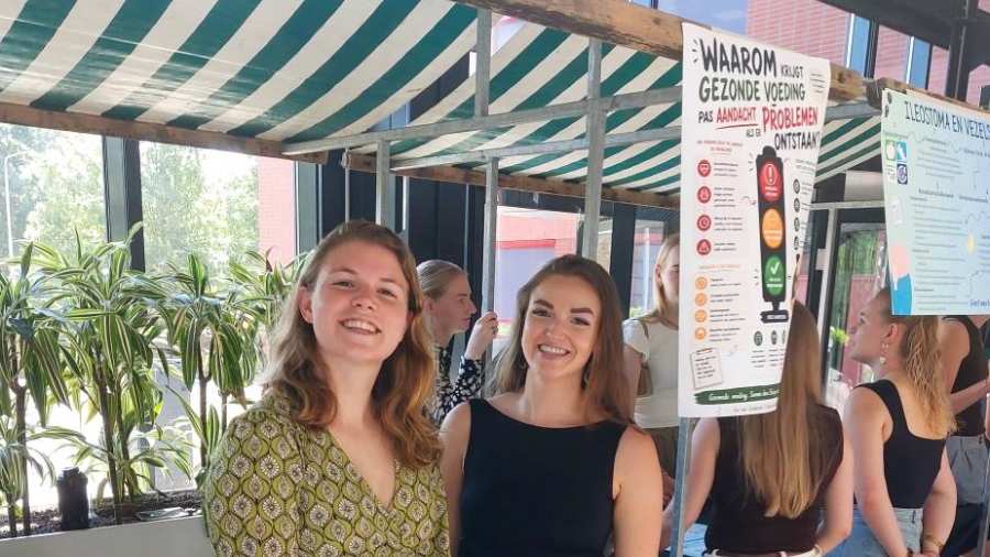 Studenten Marjan en Ilse tijdens PZW presenteert vertellen over hun PZW project bij Humanitas DMH