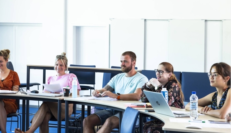 Studenten van de Master Social Work lachen tijdens uitleg