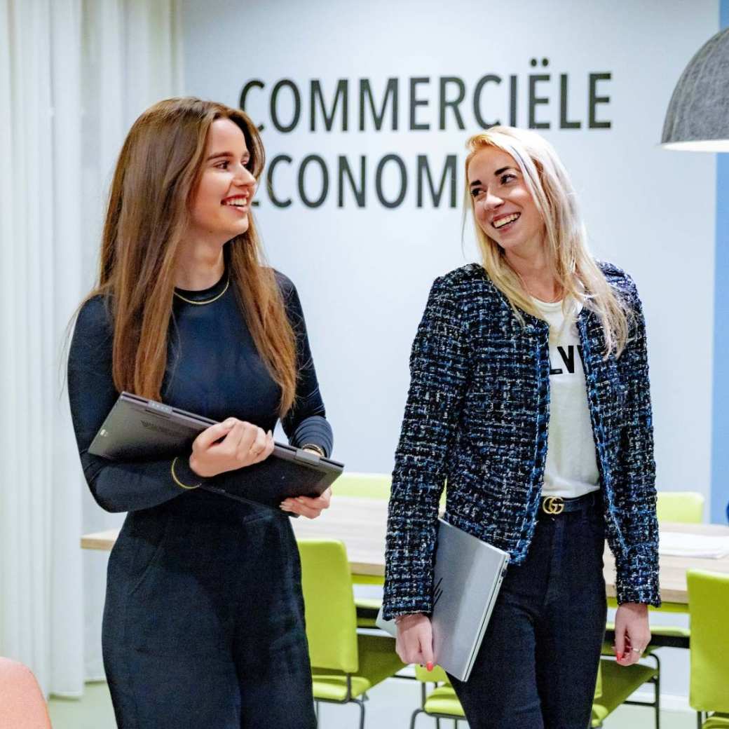 Studenten van de associate degree Commerciële Economie deeltijd, duaal lopend in lounge overleg.