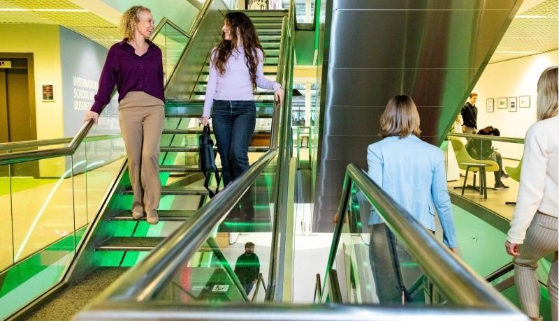 twee studenten Strategisch HRM praten in de gang van de HAN-campus
