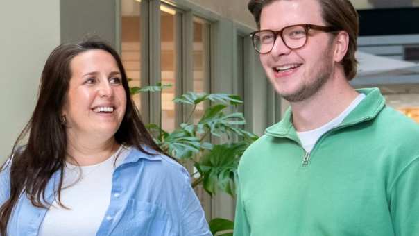 2 masterstudenten lopen op de gang