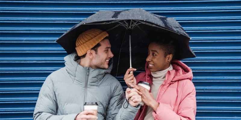 Een man en vrouw samen onder een paraplu