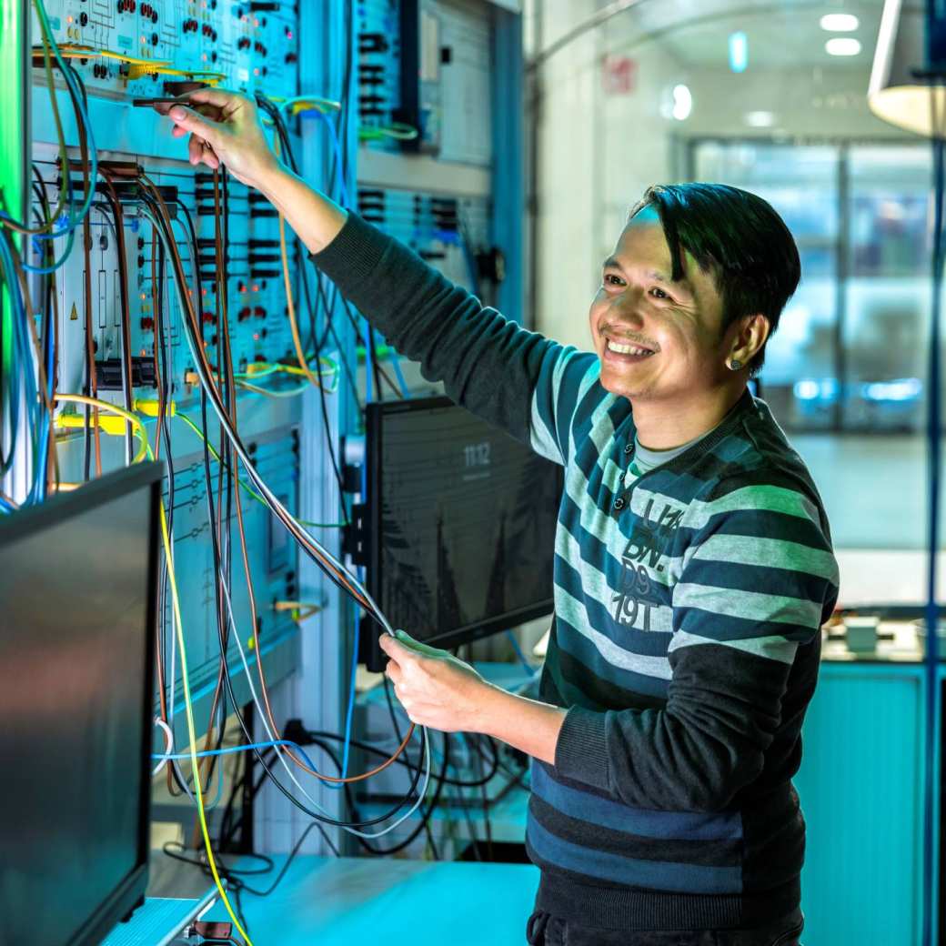 Lachende man test de installatie van de smart grid in de WATTS simulatieruimte.