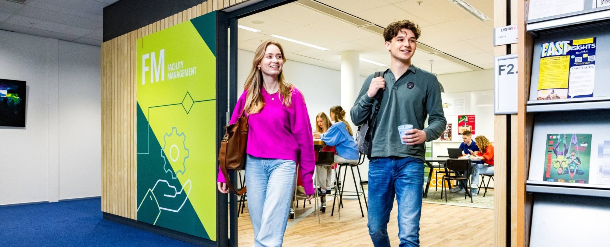 vijf studenten van de opleiding facility management lopen in het HAN campus gebouw in Nijmegen